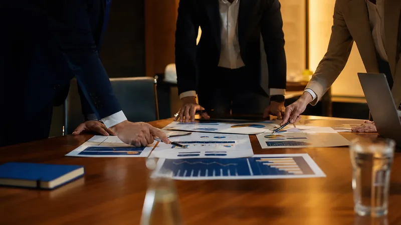 Advisors reviewing growth charts at a conference table, Michigan Small Business Grants and Funding
